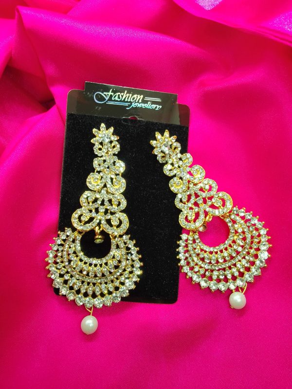 Golden earrings with diamond cuts for added sparkle on a metal base."