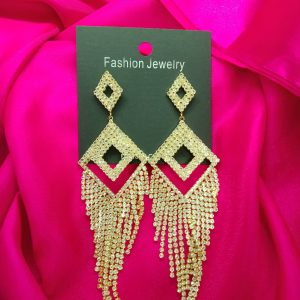 Golden earrings with diamond-cut stones reflecting light