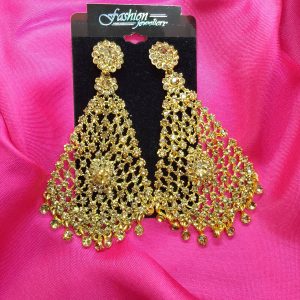 "Golden earrings with diamond cut stones hanging elegantly."