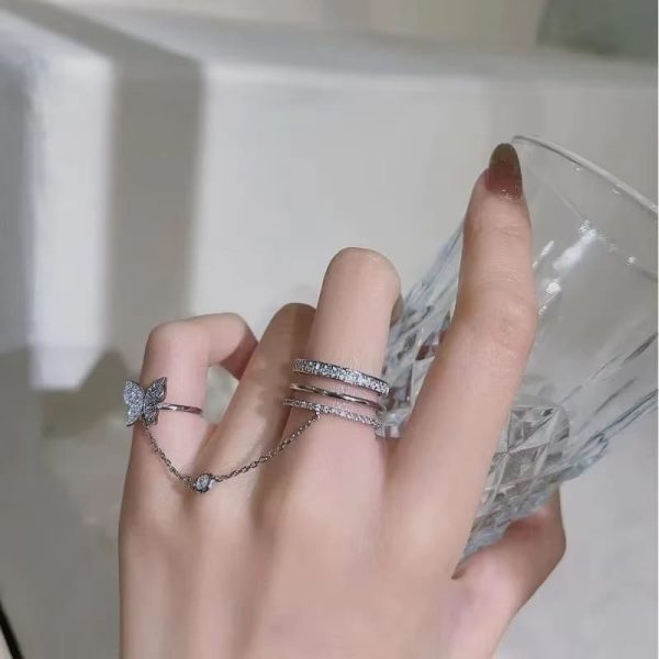 "Silver color crystal butterfly tassel ring with geometric chain design for women"